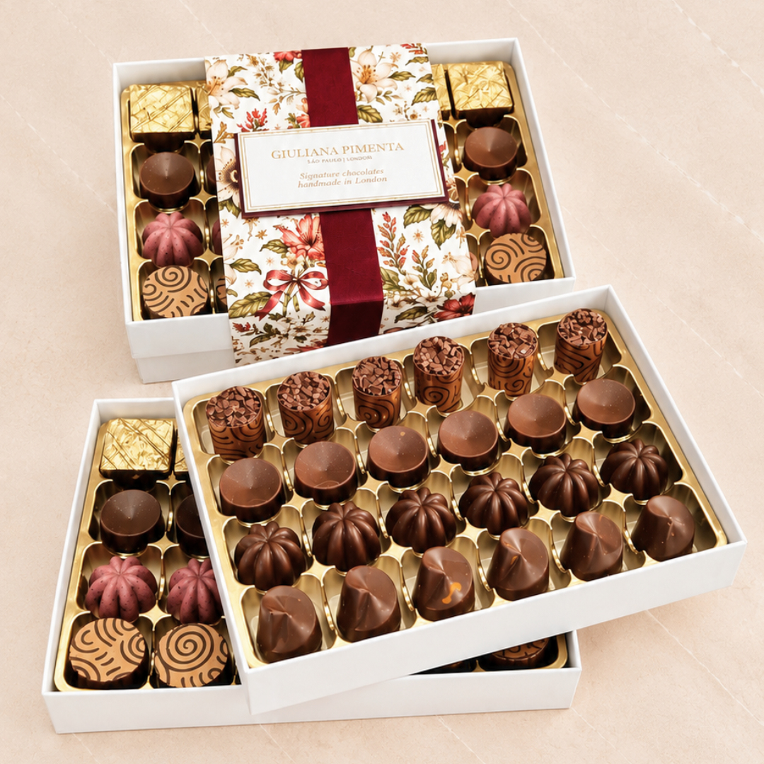 Forty-eight chocolates in an open box with a burgundy ribbon, eight flavours from our Christmas collections
