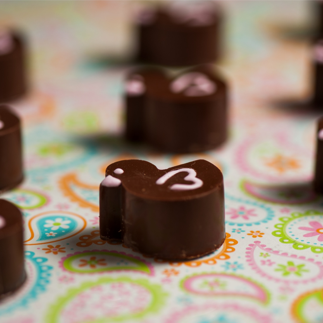 personalised Duck shaped chocolates for a themed kids party with light pink details in royal icing