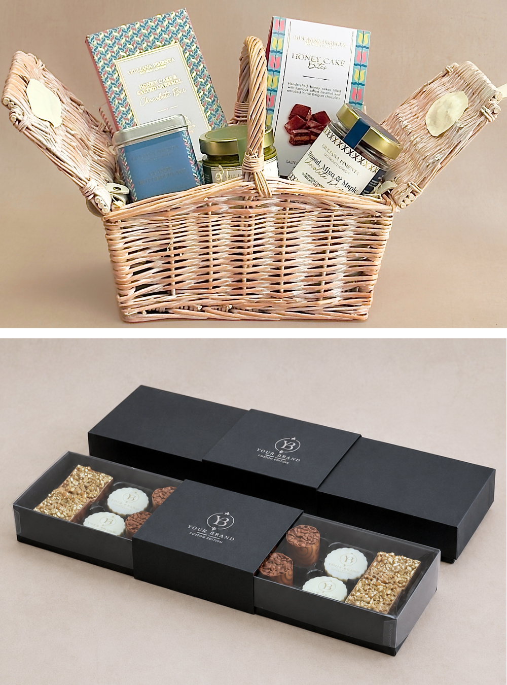 A wicker gift basket filled with assorted packaged items and a separate black gift box shown open, containing chocolates and sweets, on a plain beige background. Both used as examples of the comprehensive range of luxury chocolate corporate gifts offered by Giuliana Pimenta in the UK, all handmade in their London atelier and personalised to order, according to the customer needs. 