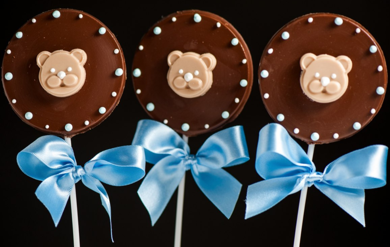 Luxury Teddy bear personalised chocolate lollypop with blue satin ribbon and white and blue hand piped royal icing dots