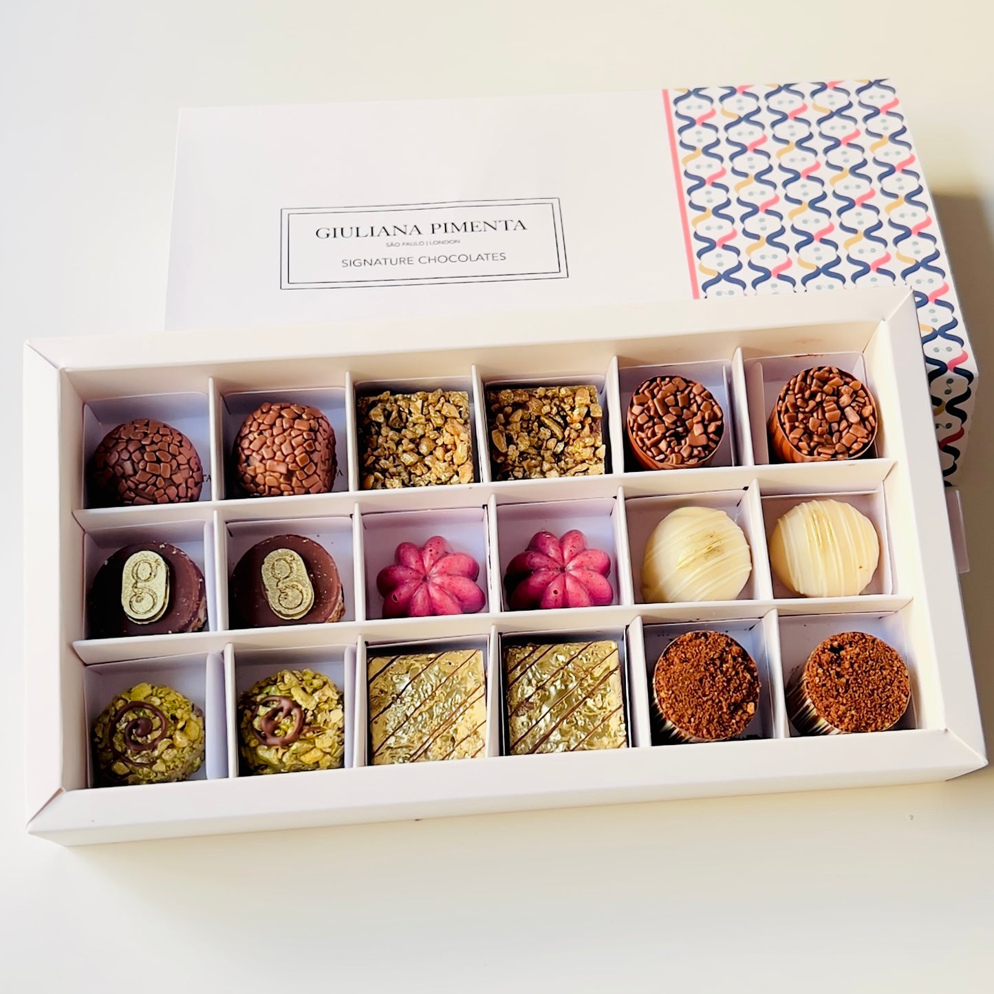
                  
                    Luxury artisan chocolate gift box with 18 handcrafted chocolates by Giuliana Pimenta Chocolates
Handcrafted chocolate selection box, curated monthly by Giuliana Pimenta Chocolates atelier
Premium surprise chocolate box UK — The Discovery Box by Giuliana Pimenta Chocolates
                  
                