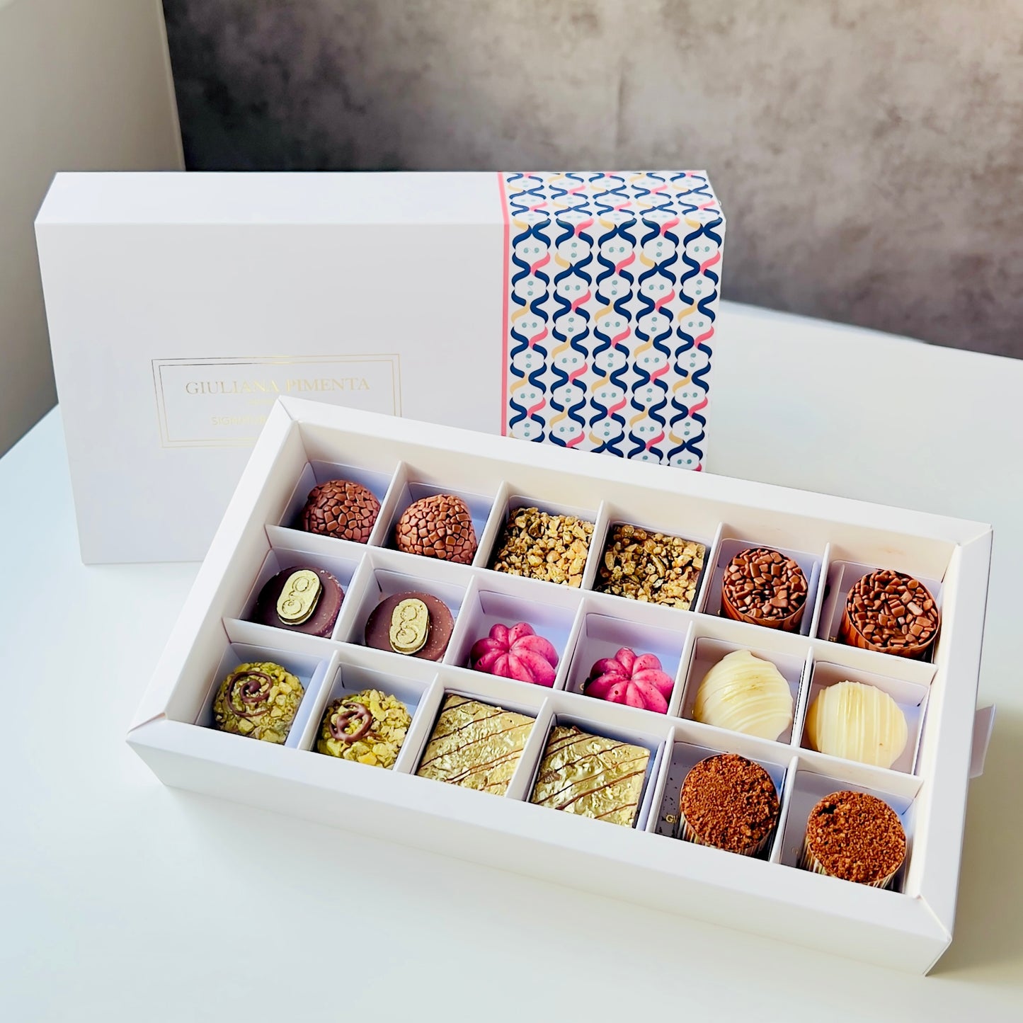 
                  
                    Luxury artisan chocolate gift box with 18 handcrafted chocolates by Giuliana Pimenta Chocolates
Handcrafted chocolate selection box, curated monthly by Giuliana Pimenta Chocolates atelier
Premium surprise chocolate box UK — The Discovery Box by Giuliana Pimenta Chocolates
                  
                